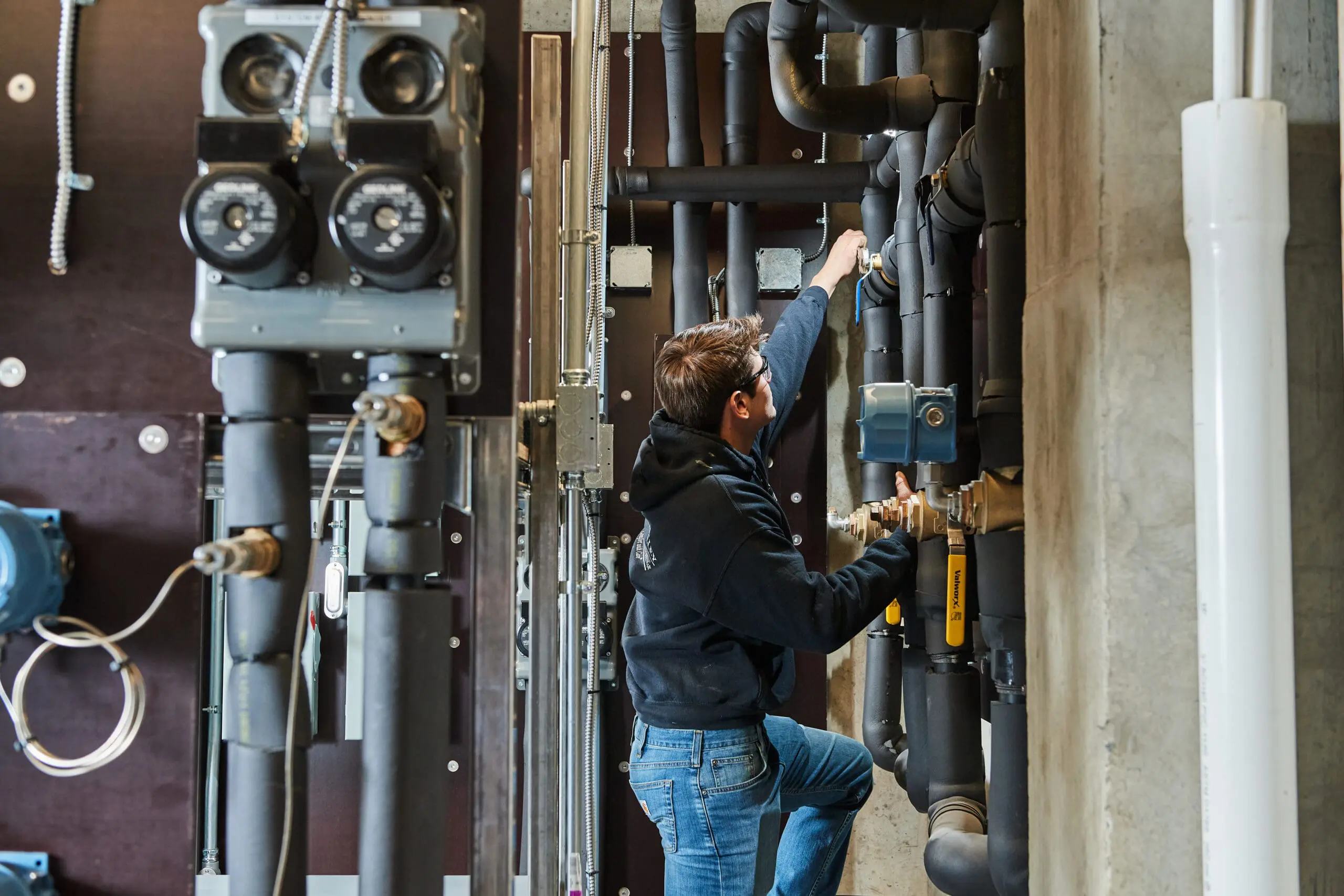 image of a BVHVAC technician working on system