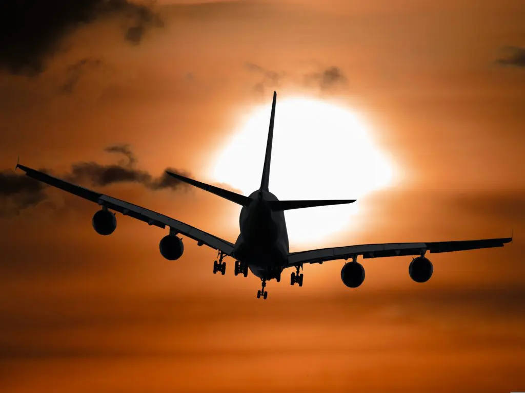 garten-gg-plane-1362587 | Brandywine Valley Heating & Air Conditioning Silhouette of a large passenger airplane with landing gear down, approaching the runway against an orange sunset sky