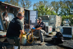 image of a BVHVAC technician working on system