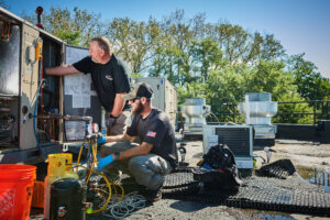 image of a BVHVAC technician working on system