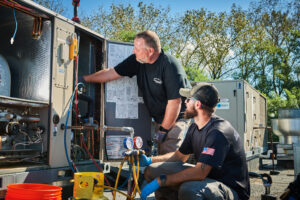 image of a BVHVAC technician working on system