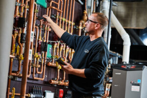 image of a BVHVAC technician working on system