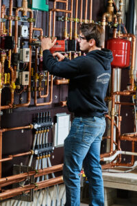 image of a BVHVAC technician working on system