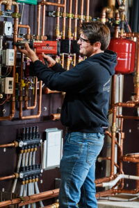image of a BVHVAC technician working on system