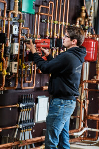 image of a BVHVAC technician working on system