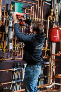image of a BVHVAC technician working on system