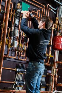 image of a BVHVAC technician working on system