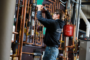 image of a BVHVAC technician working on system