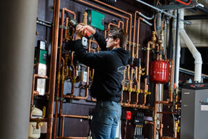 image of a BVHVAC technician working on system