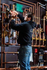 image of a BVHVAC technician working on system
