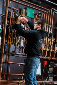 image of a BVHVAC technician working on system