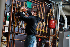 image of a BVHVAC technician working on system