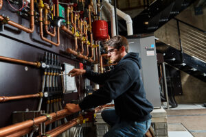 image of a BVHVAC technician working on system