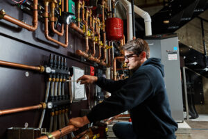 image of a BVHVAC technician working on system