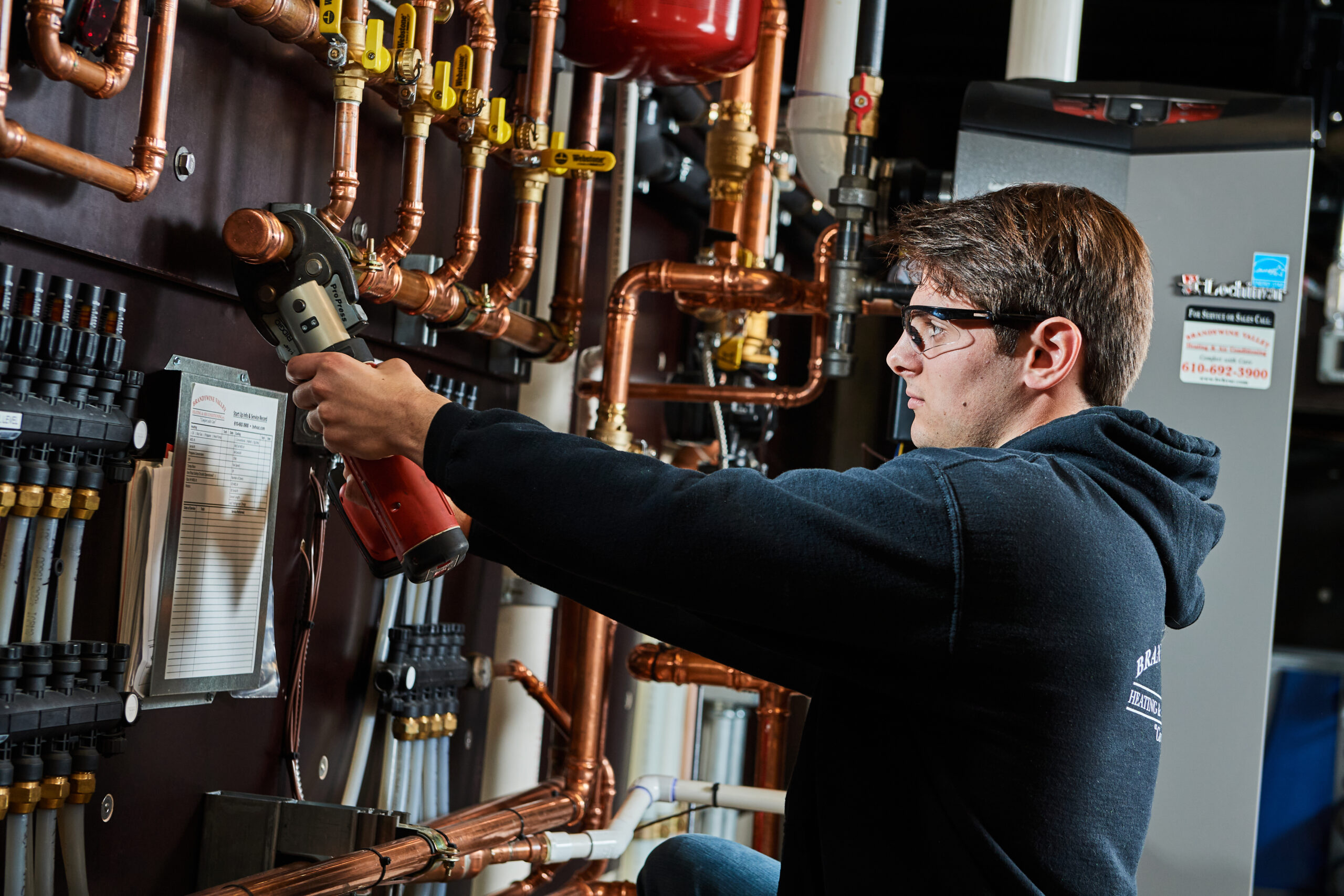 023- PhilipGabrielPhotography-BVHVAC 12.6.21 image of a BVHVAC technician working on system