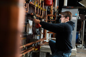 image of a BVHVAC technician working on system