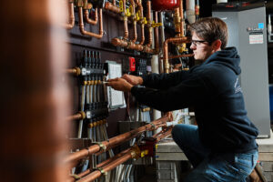 image of a BVHVAC technician working on system