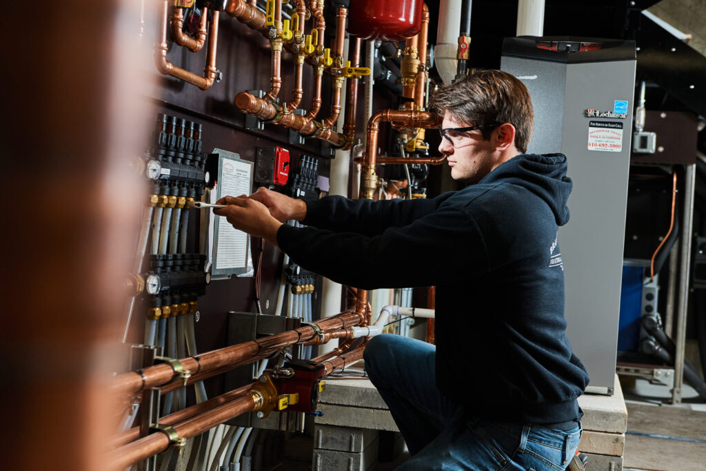 image of a BVHVAC technician working on system