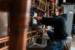 image of a BVHVAC technician working on system