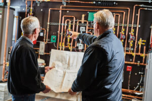 image of a BVHVAC technician working on system