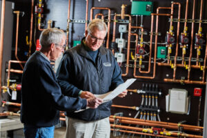 image of a BVHVAC technician working on system