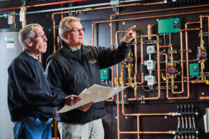 image of a BVHVAC technician working on system