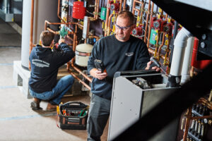 image of a BVHVAC technician working on system