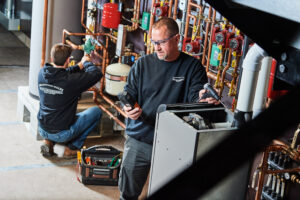 image of a BVHVAC technician working on system