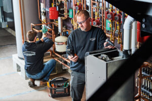 image of a BVHVAC technician working on system
