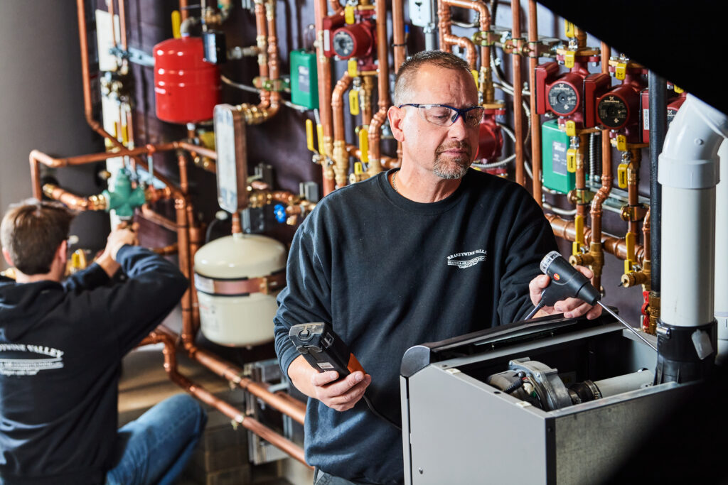 image of a BVHVAC technician working on system