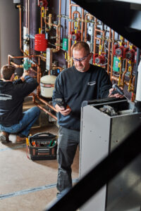 image of a BVHVAC technician working on system