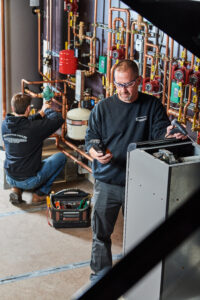image of a BVHVAC technician working on system