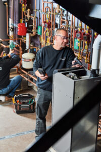 image of a BVHVAC technician working on system