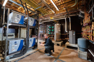 image of a BVHVAC technician working on system