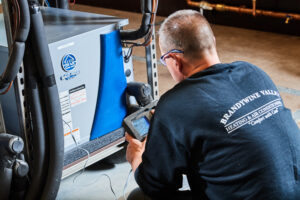 image of a BVHVAC technician working on system