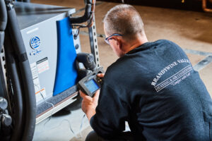 image of a BVHVAC technician working on system