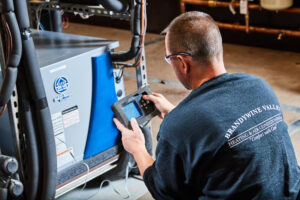 image of a BVHVAC technician working on system