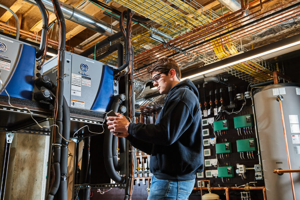 image of a BVHVAC technician working on system