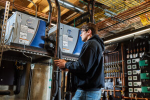 image of a BVHVAC technician working on system