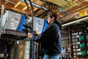 image of a BVHVAC technician working on system