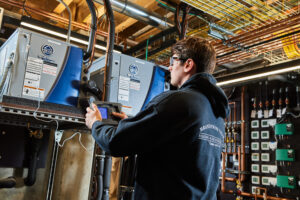 image of a BVHVAC technician working on system