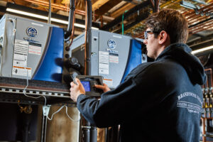 image of a BVHVAC technician working on system
