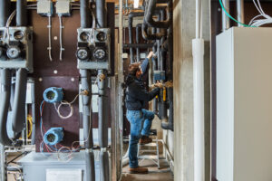 image of a BVHVAC technician working on system
