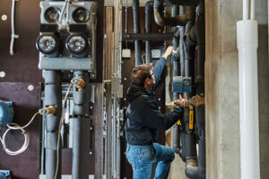 image of a BVHVAC technician working on system