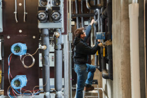 image of a BVHVAC technician working on system