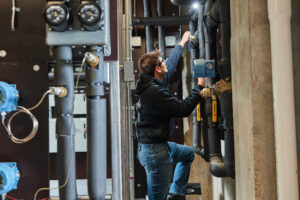 image of a BVHVAC technician working on system