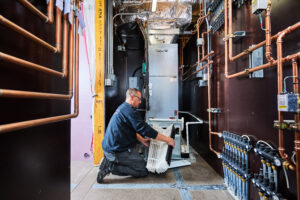 image of a BVHVAC technician working on system