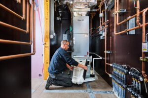image of a BVHVAC technician working on system