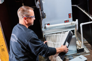 image of a BVHVAC technician working on system
