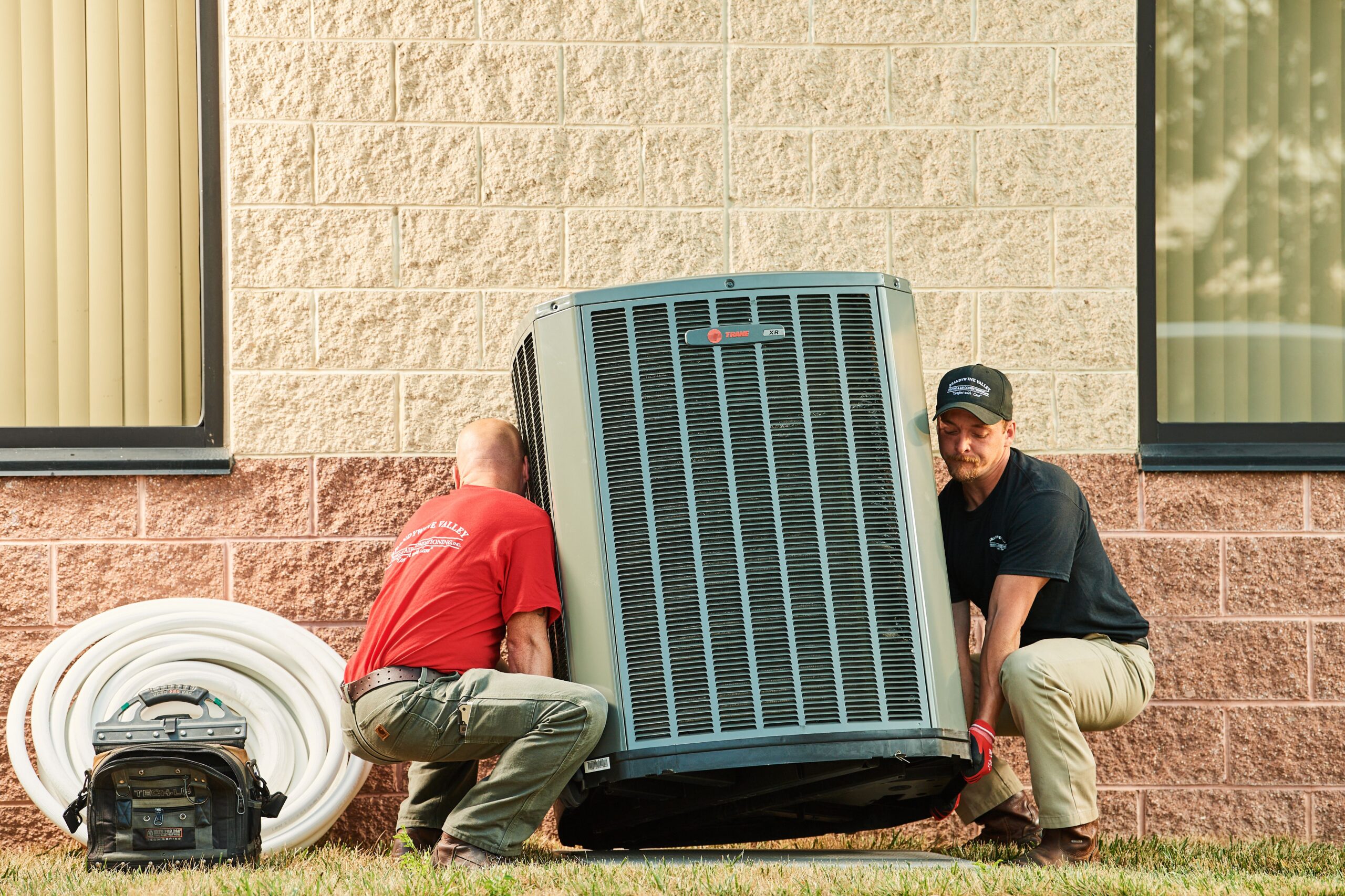 image of a BVHVAC technician working on system